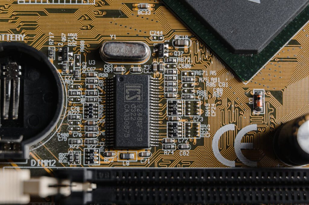 pexels-photo-6755058-1 Detailed view of circuit components on a printed circuit board (PCB).